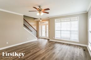 Gallatin house for rent - A spacious room with a staircase and a ceiling fan.