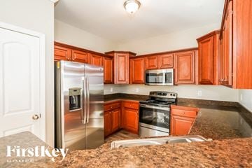 Gallatin house for rent - A kitchen with wooden cabinets and stainless steel appliances.