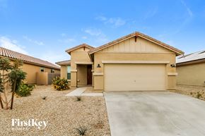 Surprise house for rent - a beige house with a garage and a driveway