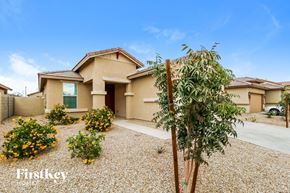 Surprise house for rent - a house with a yard and a tree in front of it