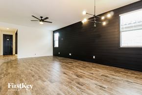 Surprise house for rent - the living room with wood floors and a black accent wall