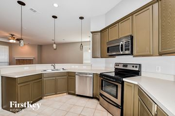 Arlington house for rent - A kitchen with brown cabinets and a white counter top.