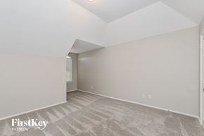 Arlington house for rent - A spacious room with a carpeted floor and a skylight.