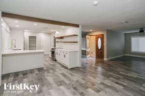 Glendale house for rent - A spacious kitchen with a white countertop and a wooden door.