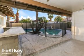 Glendale house for rent - A pool enclosed by a black fence with a FirstKey Homes logo.