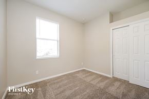North Port house for rent - a bedroom with two closets and a window and carpeting