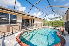 North Port house for rent - a resort style pool with a glass roof on top of a house