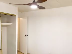 Show Low house for rent - A room with a ceiling fan and a door.