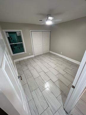 Decatur apartment for rent - A room with a white ceiling fan and a white door.