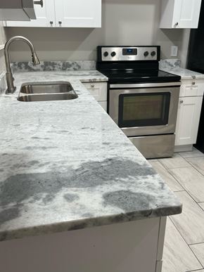 Decatur apartment for rent - A kitchen with a marble countertop and stainless steel appliances.