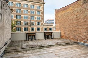 Sioux Falls apartment for rent - the deck on the top of the building has a table and two stools
