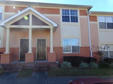 Tallahassee apartment for rent - A red car is parked in front of a house with a green door.