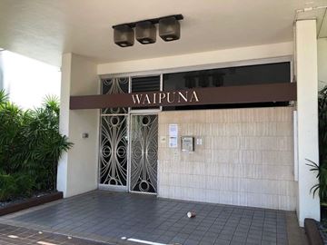 Honolulu apartment for rent - The entrance to a building with the name "WAIPUNA" on it.