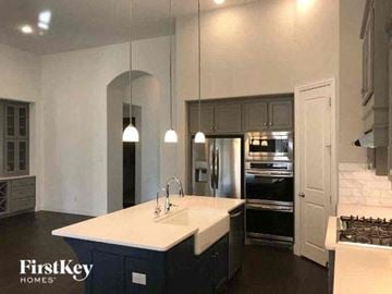 Aledo house for rent - A kitchen with a white countertop and dark cabinets.