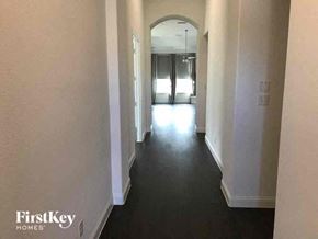 Aledo house for rent - A long hallway with a FirstKey Homes logo on the bottom left.