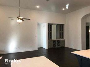 Aledo house for rent - A spacious room with a ceiling fan and a large window.