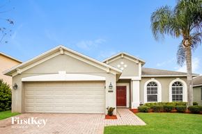 Orlando house for rent - A house with a red door and a garage door.