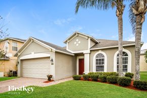 Orlando house for rent - A house with a palm tree in front of it.