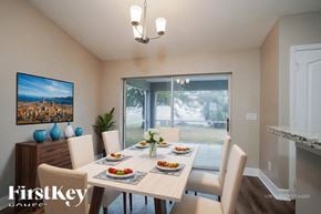 Cape Coral house for rent - A dining room with a table set for a meal.