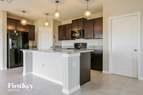 Ruskin house for rent - a kitchen with a large island and black appliances
