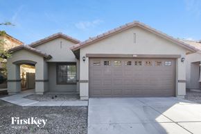 Surprise house for rent - A house with a garage and a driveway in front of it.