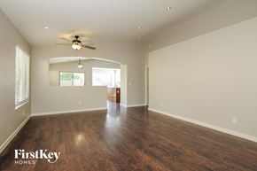 Surprise house for rent - A spacious room with wooden floors and a ceiling fan.