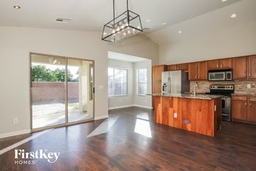 Surprise house for rent - A kitchen with wooden cabinets and a wooden island with a microwave on top.