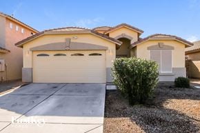 San Tan Valley house for rent - a home with a white garage door and a driveway