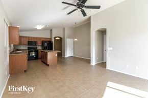 San Tan Valley house for rent - an empty kitchen and living room with a ceiling fan