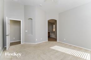 San Tan Valley house for rent - a master bedroom with a carpeted floor and a door to a bathroom