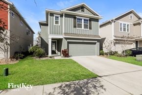 Sanford house for rent - a green two story house with a garage and a lawn