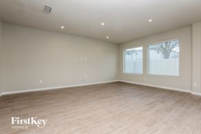 Sanford house for rent - the spacious living room with wood flooring and large windows