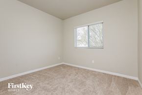 Sanford house for rent - a bedroom with a window and a carpeted floor
