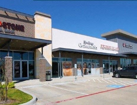 Pearland apartment for rent - the front of a store with a parking lot