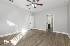 Jacksonville house for rent - a living room with hardwood floors and a ceiling fan