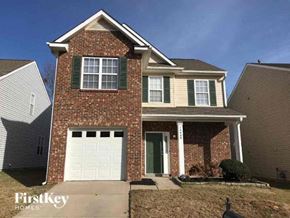 Charlotte house for rent - a brick house with a white garage door