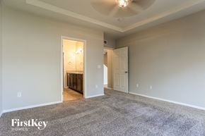 Denver house for rent - A spacious room with a carpeted floor and a ceiling fan.