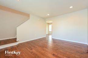 Parker house for rent - the living room and dining room with hardwood floors and white walls