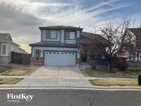 Commerce City house for rent - a suburban house with a white garage door