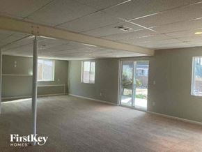 Commerce City house for rent - an empty room in a building with a glass door