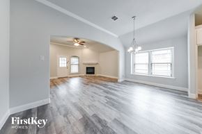 Dallas house for rent - the living room and dining room with wood flooring and a fireplace