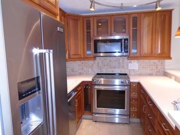 Honolulu apartment for rent - A kitchen with a stainless steel refrigerator and oven.