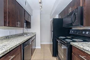 Houston apartment for rent - a kitchen with black appliances and granite counter tops and