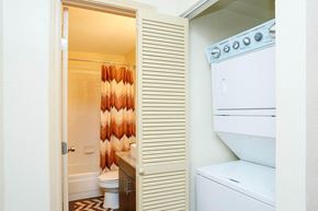 Houston apartment for rent - a bathroom with a washer and dryer and a closet