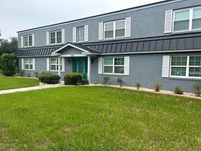 Winter Park apartment for rent - a blue house with a green lawn in front of it