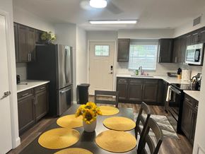 Winter Park apartment for rent - an open kitchen and dining room with a table and sunflowers