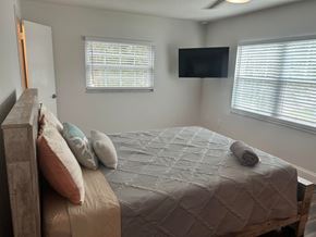 Winter Park apartment for rent - a bedroom with a bed and a tv on the wall