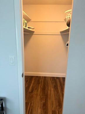 Winter Park apartment for rent - a walk in closet with shelves and a wood floor