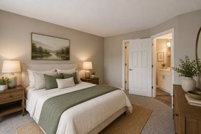 Largo apartment for rent - A bedroom with a large bed and a painting on the wall.