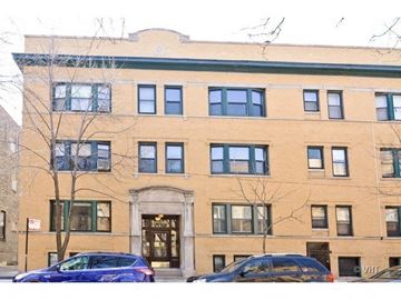 Chicago apartment for rent - two cars parked in front of a brick building